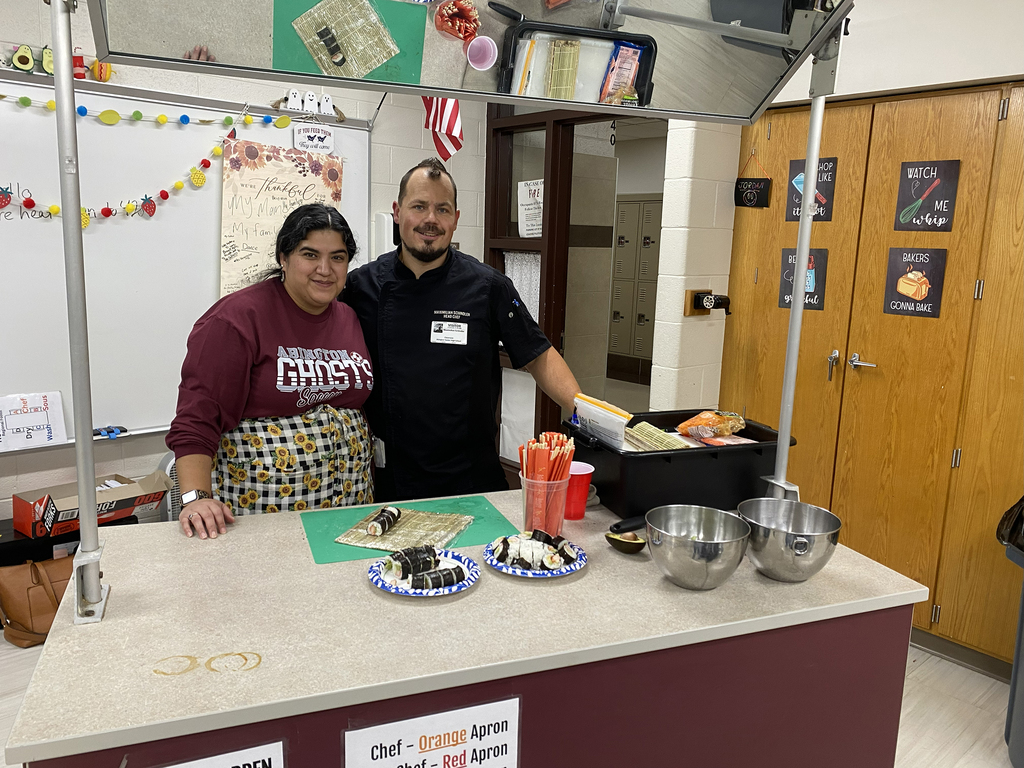 Ms. Vanassche and Chef Schindler stand behind successfully rolled and sliced sushi