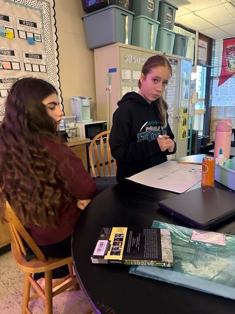 Image of 6th grade students making signs for high school soccer state champs.