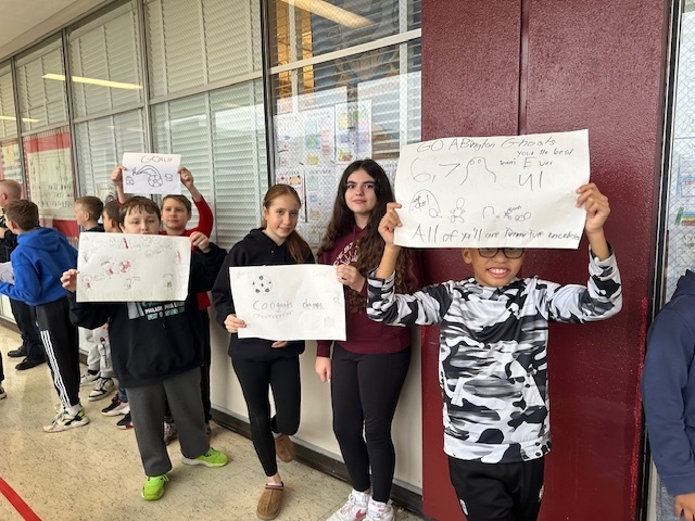 Image of 6th grade students making signs for high school soccer state champs.