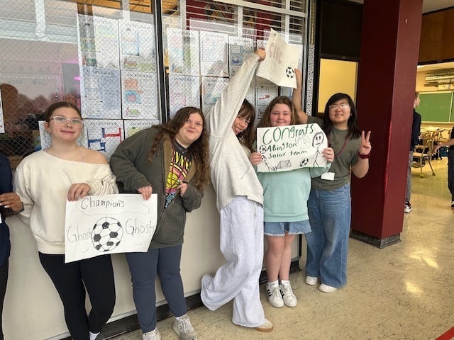 Image of 6th grade students making signs for high school soccer state champs.