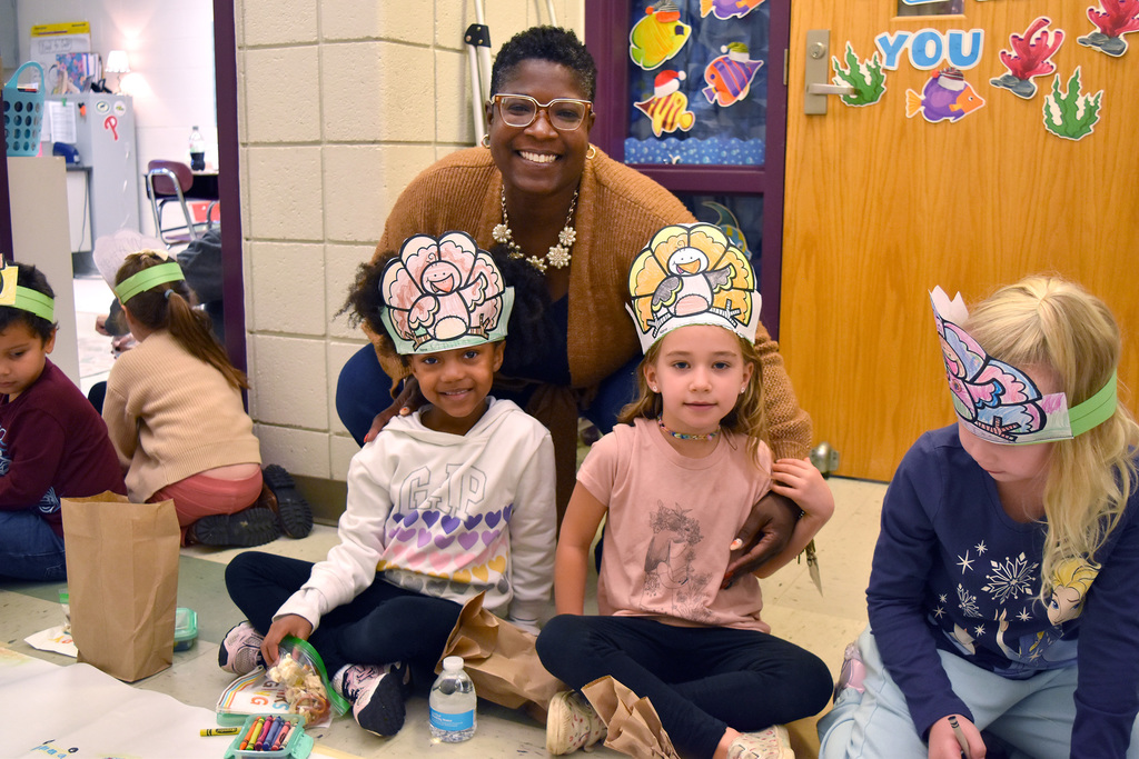 Assistant Principal Ms. Doctor with students at Friendsgiving