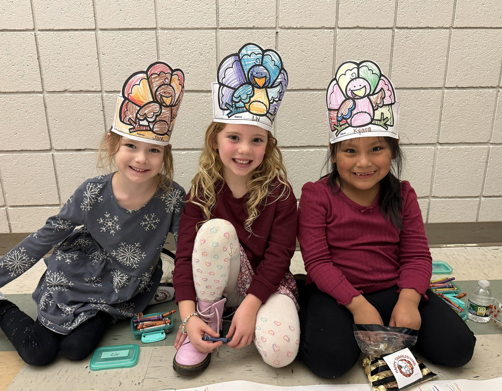3 kindergarteners smiling at Friendsgiving