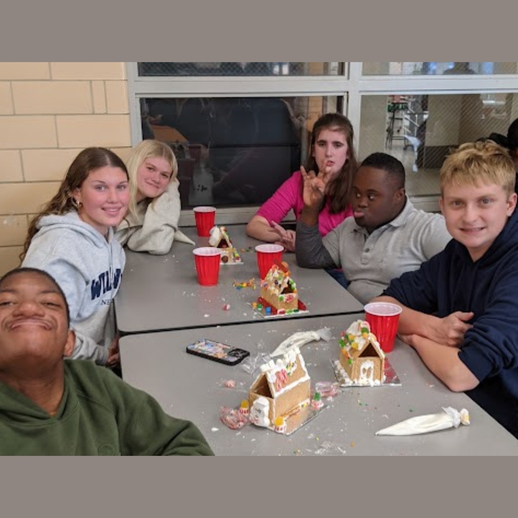 students working on gingerbread house