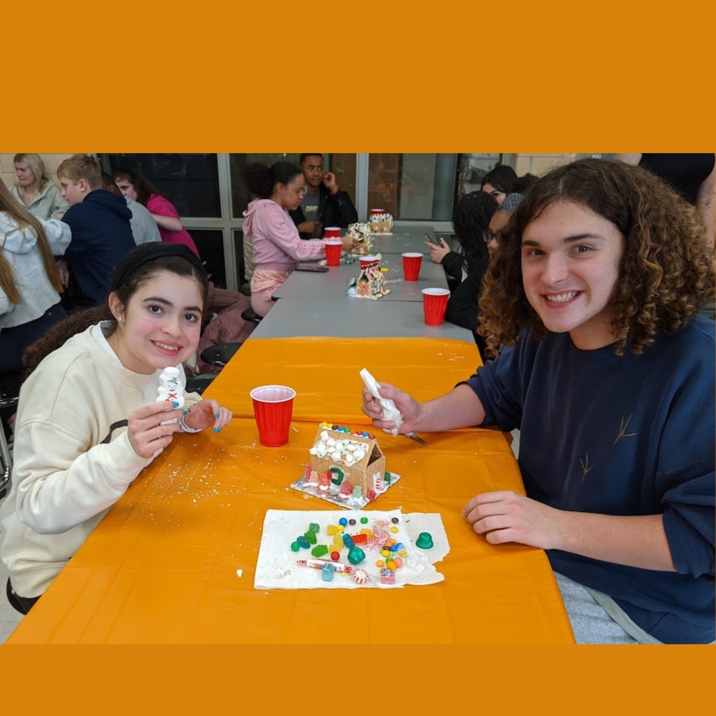 students working on gingerbread house