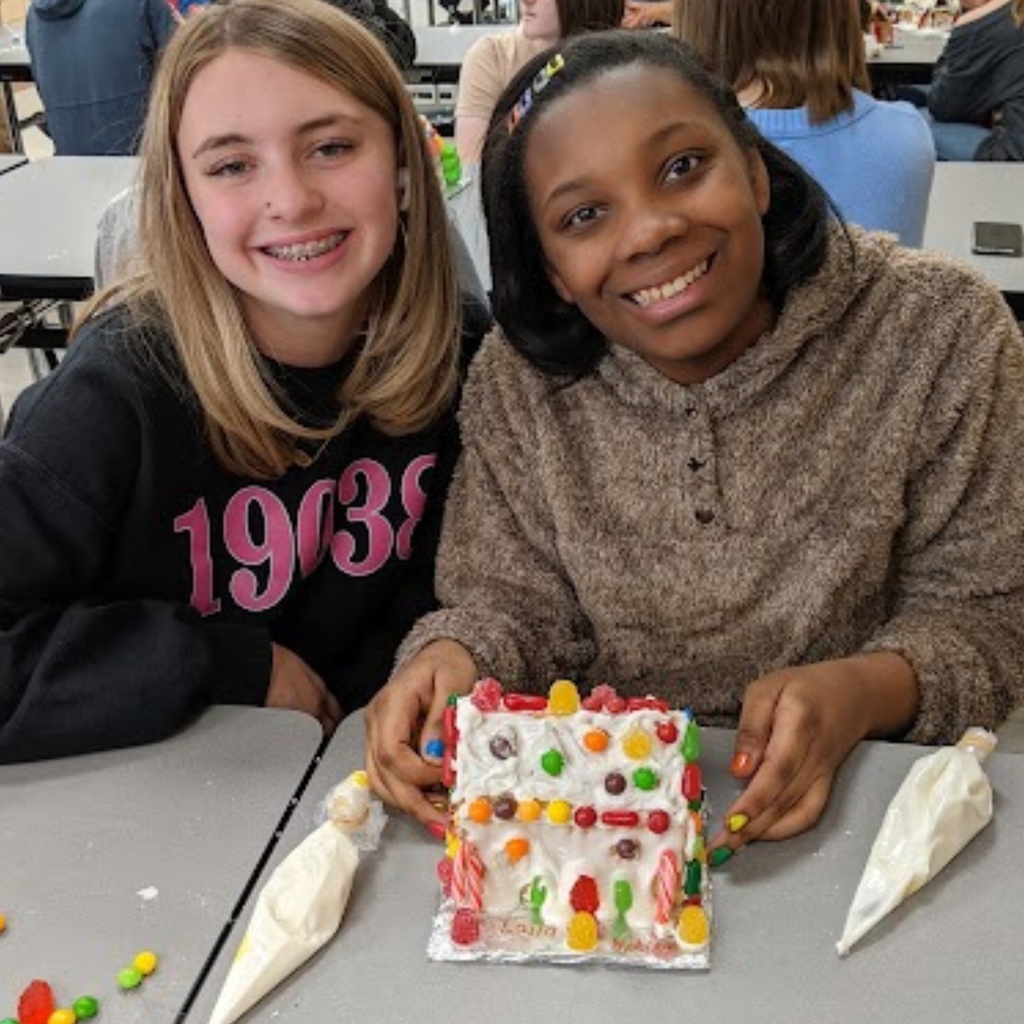 students working on gingerbread house