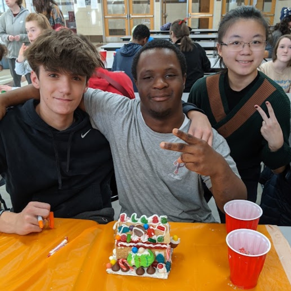 students working on gingerbread house