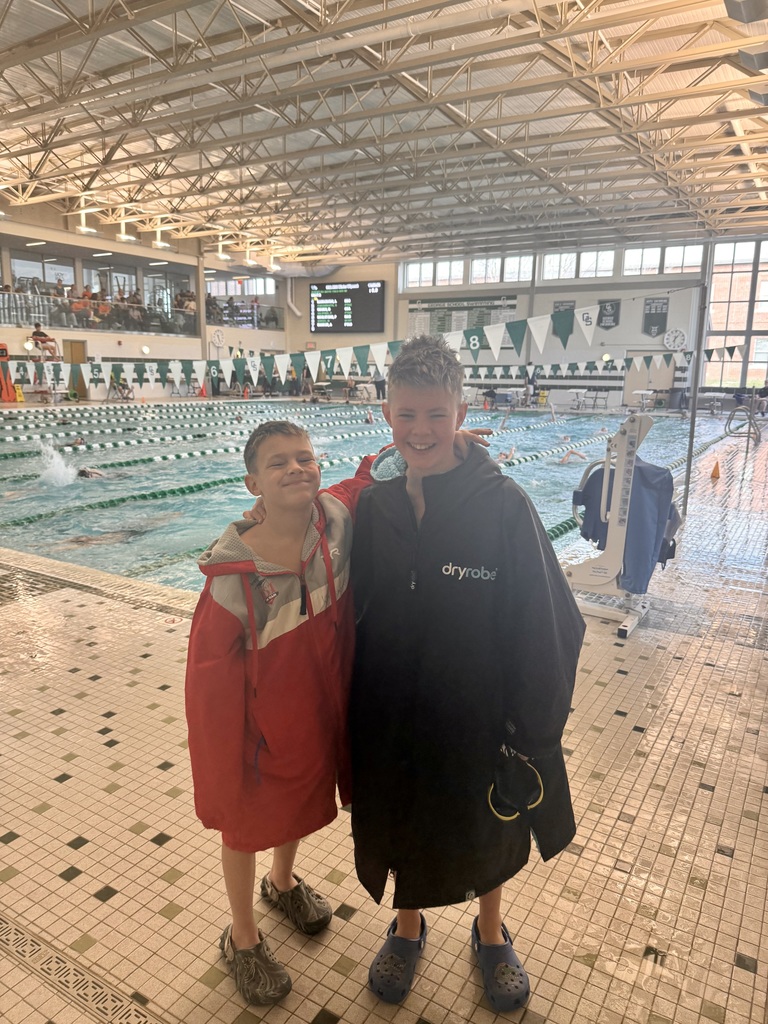 Two students standing on the pool deck.