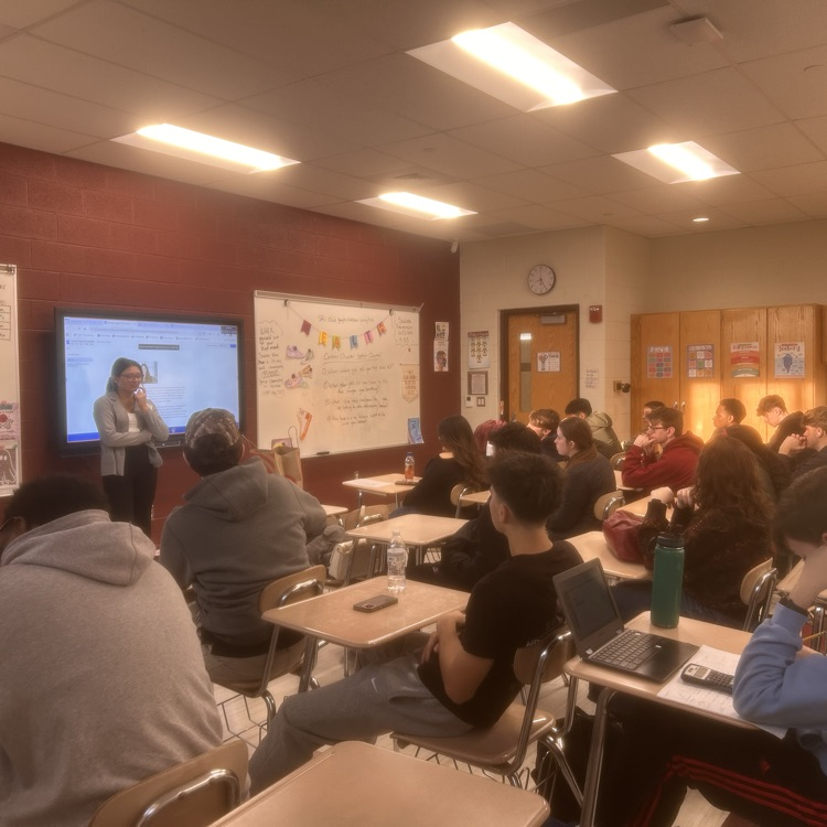 Class and presenter listening to student question
