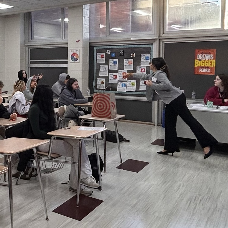 Presenter handing out candy to students