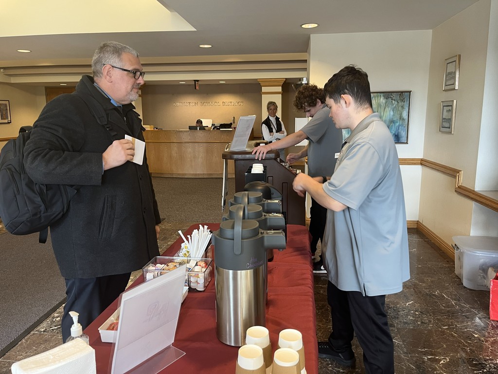 ACTIVE students make coffee for the guests as they arrive