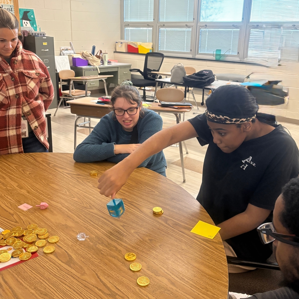 students spinning dreidels