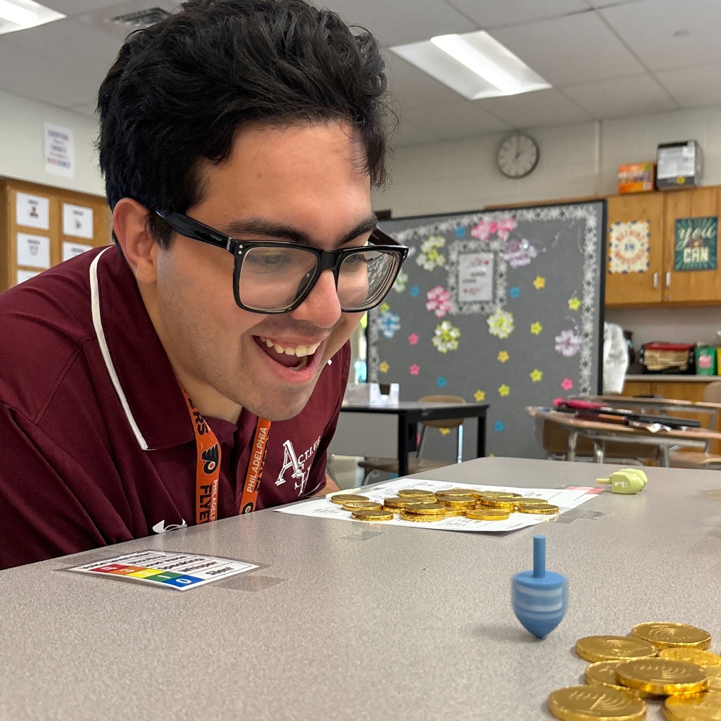 great pic of student watching dreidel spin