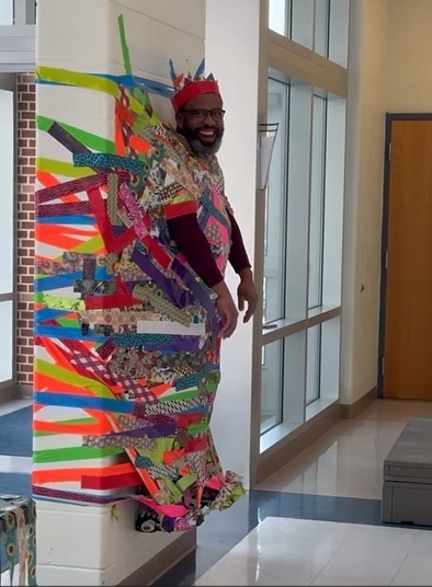 Dr. Etlen taped to the wall