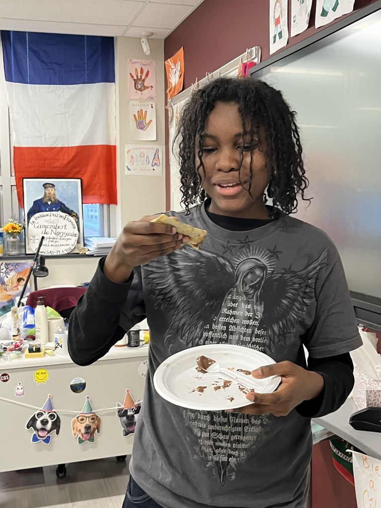 An ASHS  French 3 student tastes one of the crepes that was cooked  in class