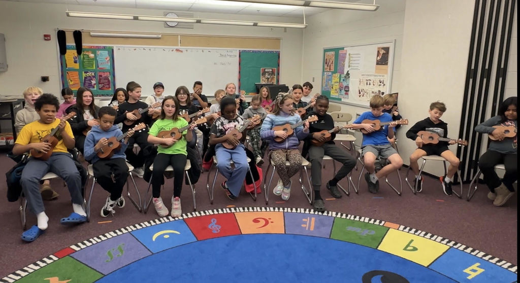 4th grade students playing  ukuleles