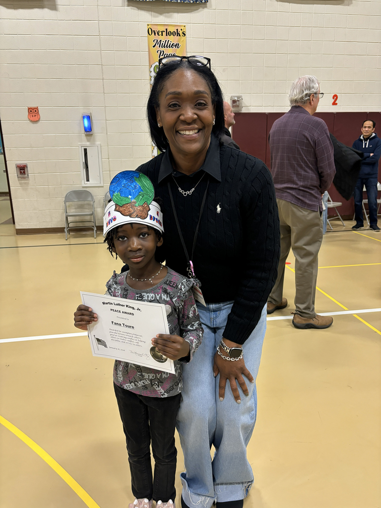 Principal Boyd stands with a student holding her MLK Peace Award