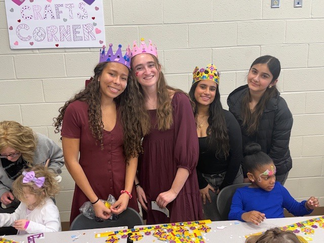 senior class members and kids doing crafts