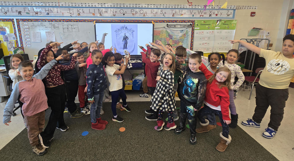 second graders smiling with Roz the Robot