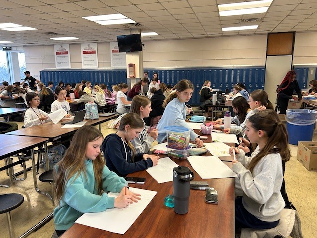 image of Builders Club members getting posters and boxes ready to distribute around AMS last month.