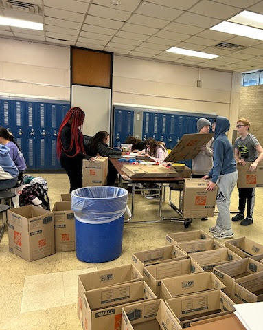 image of Builders Club members getting posters and boxes ready to distribute around AMS last month.