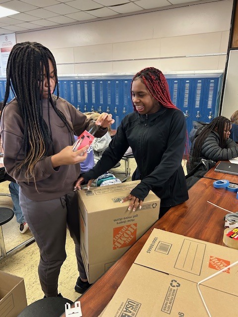 image of Builders Club members getting posters and boxes ready to distribute around AMS last month.