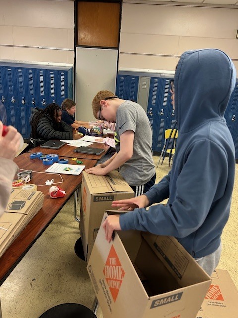 image of Builders Club members getting posters and boxes ready to distribute around AMS last month.