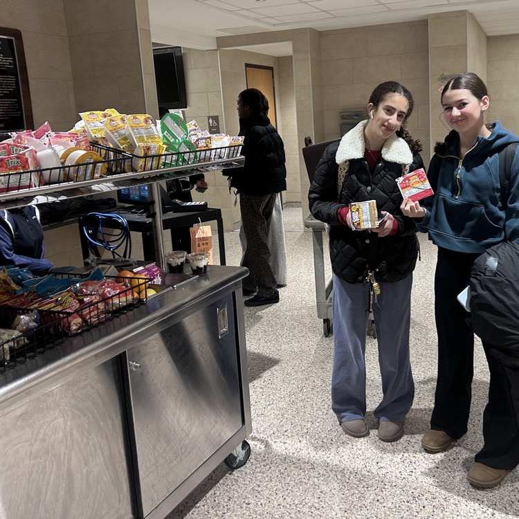 Students pickup their breakfasts at the cart