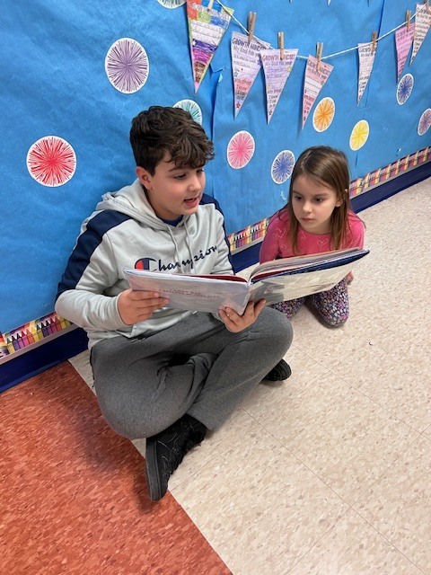 Students form a reading chain across Willow Hill