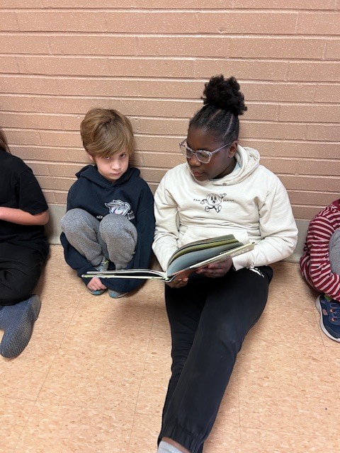 Students form a reading chain across Willow Hill