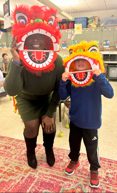 student and adult smiling with masks