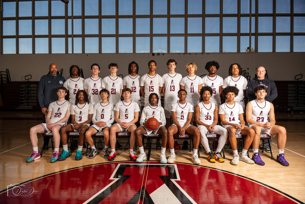 boys basketball team photo in gym with coaches