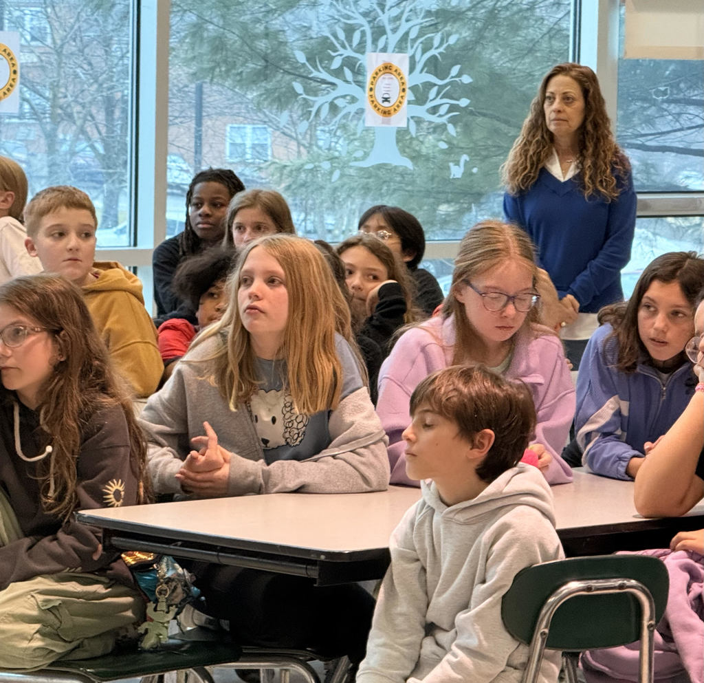 grade 5 students listening while sitting