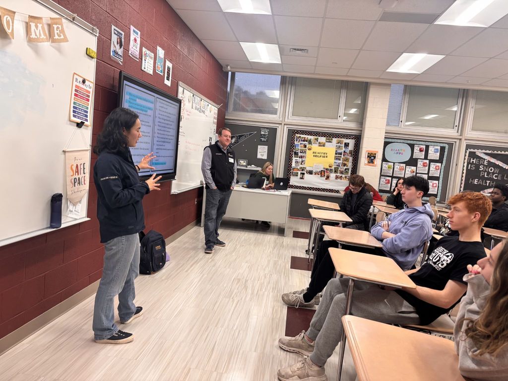 Students watch both presenters