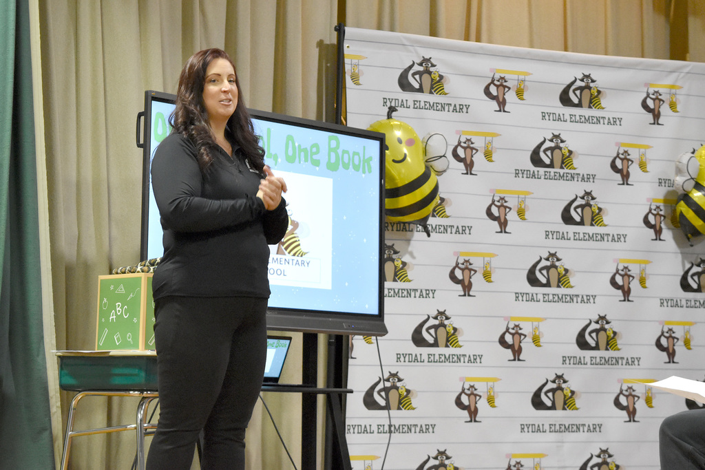 Assistant Principal Corbett speaks to volunteer readers on the stage at Rydal