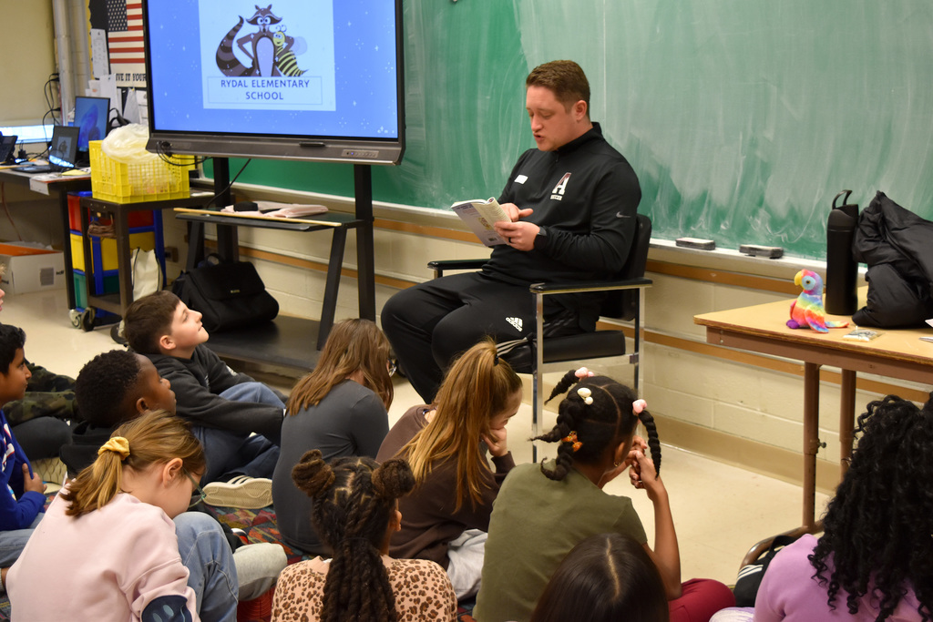 An ASD Teacher and Soccer Coach reads to Rydal students