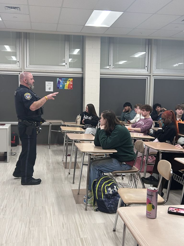 Officer Gibbs explaining his job to a classroom