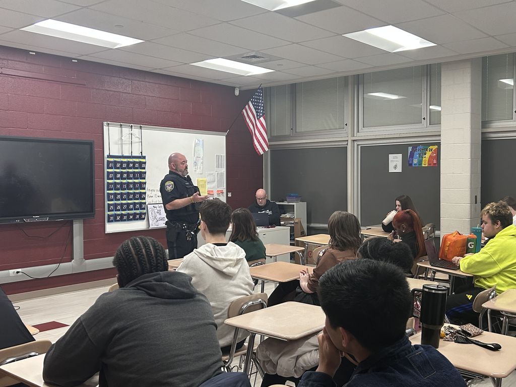 Officer Gibbs explaining his job to a classroom