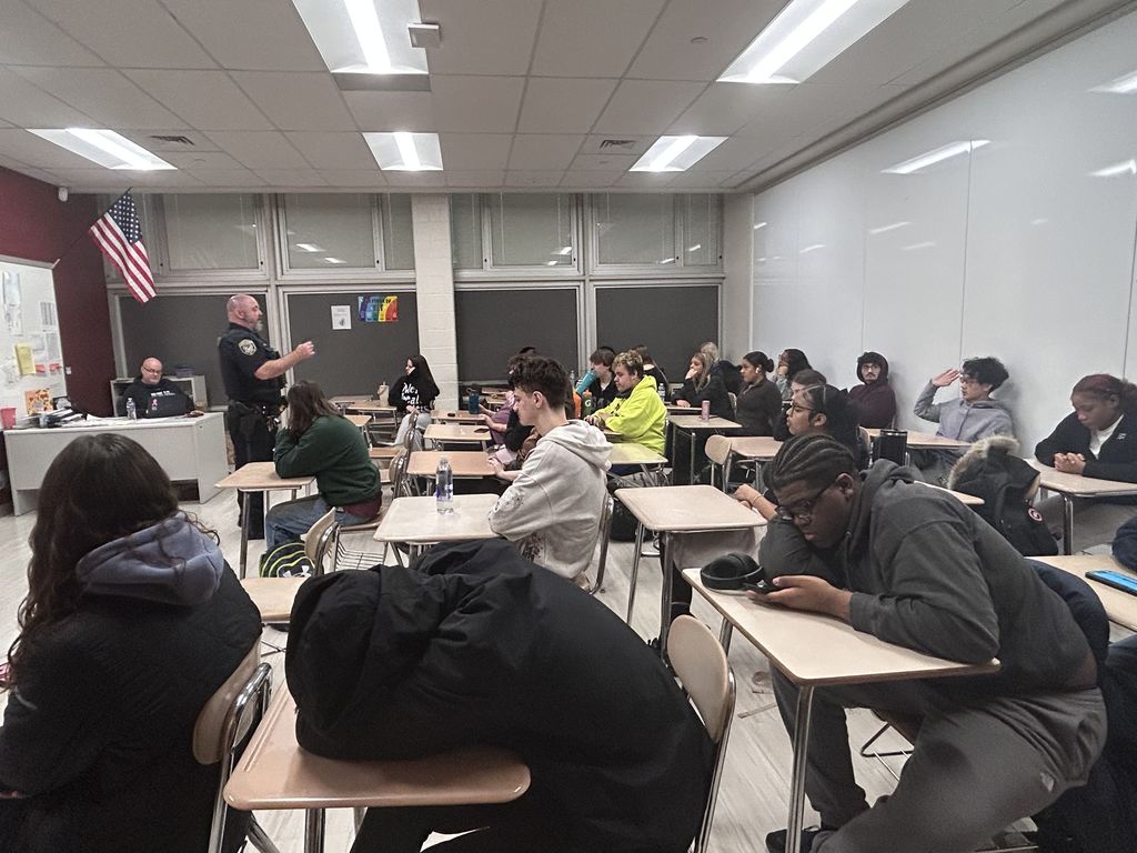 Officer Gibbs explaining his job to a classroom