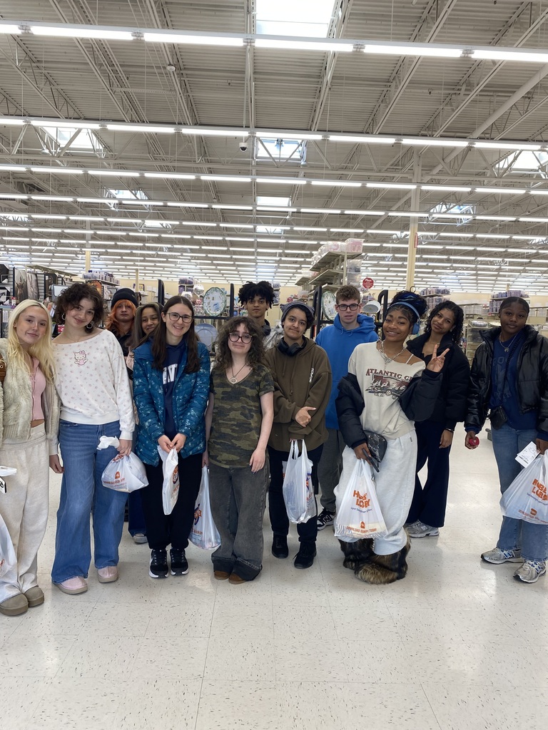 Students in the sewing class stand together for a photo