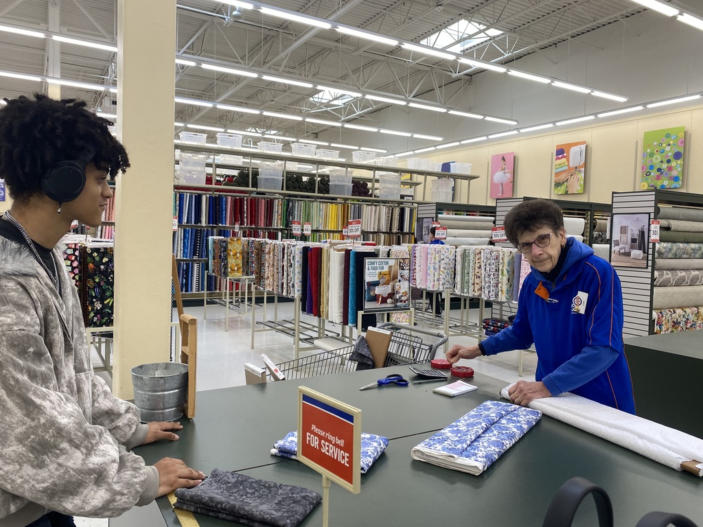 Dominick is getting his fabric measured and cut for his project