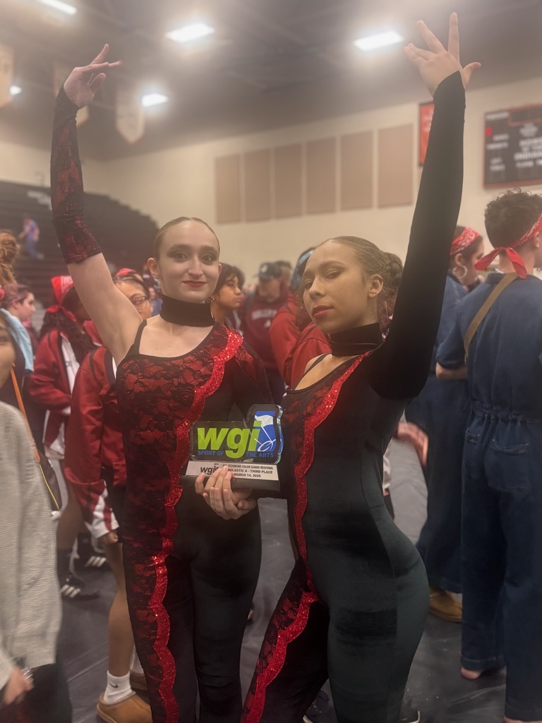Two Students, Audrey Pachuta and Lovely Rosa-DeJesus , representatives of the A Colorguard posing with their third place WGI Trophy 