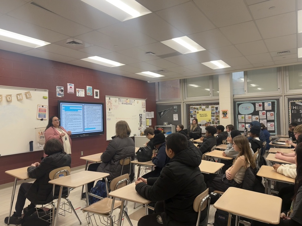 Dr. Theresa Austria is talking to the class of students.