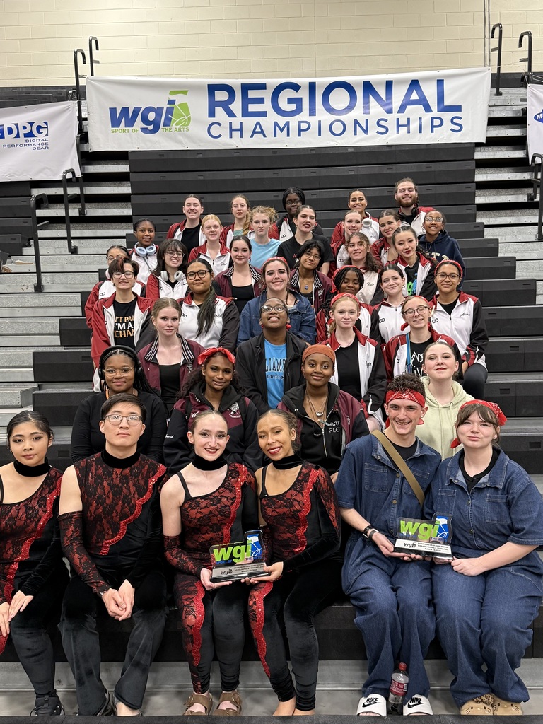 Indoor guard group shot on the bleachers at the Regional Championships