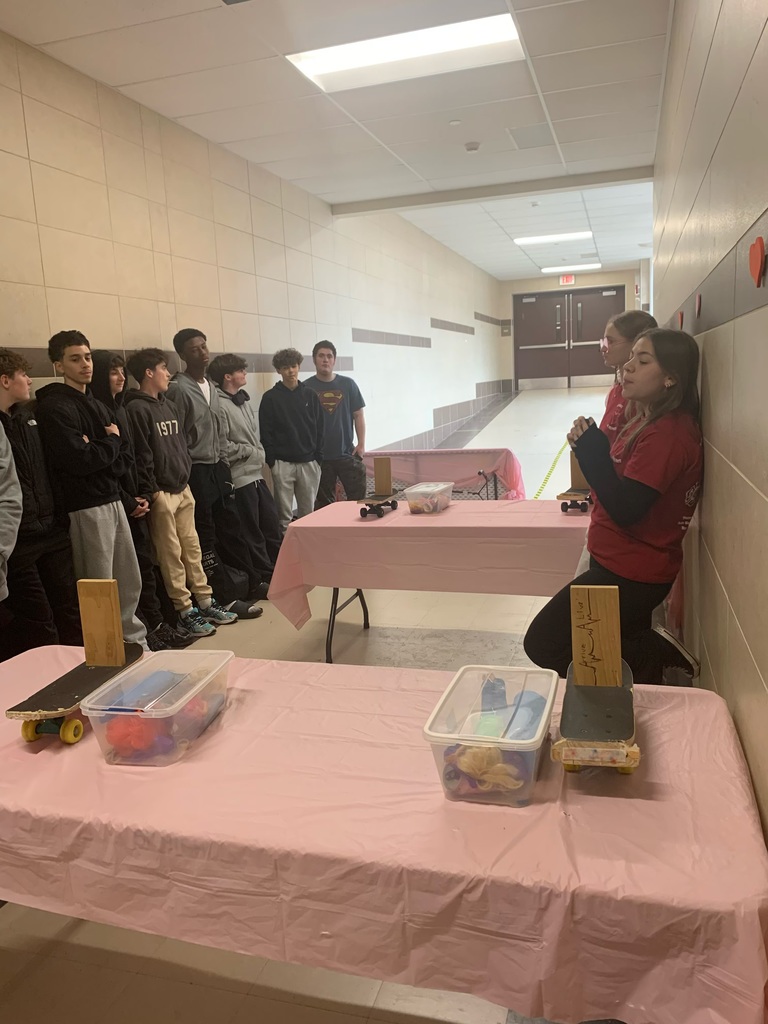 Students explaining a station to other students 