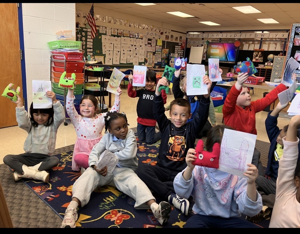 Image of kindergarteners with their felt monsters. 