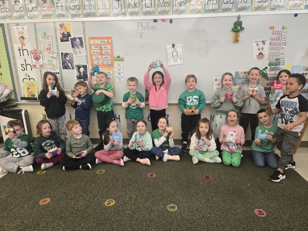 Image of kindergarteners with their felt monsters. 