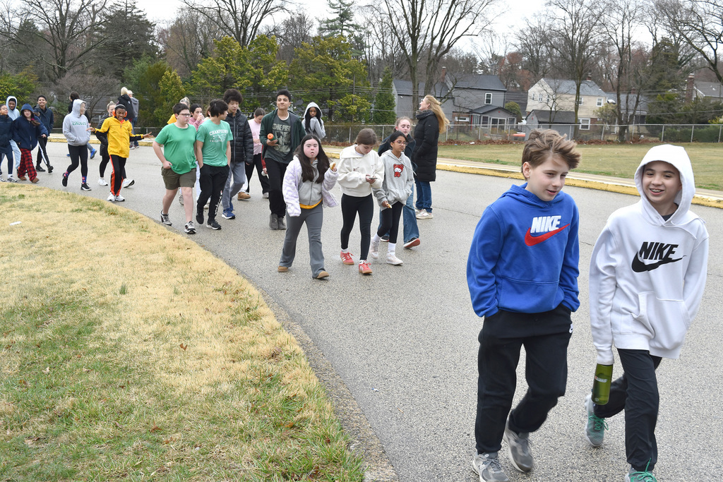 Students and teachers walk together outside during the 9th Annual Buddy Walk.