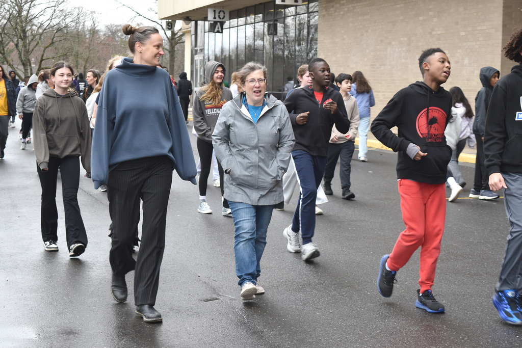 Students and teachers walk together outside during the 9th Annual Buddy Walk.