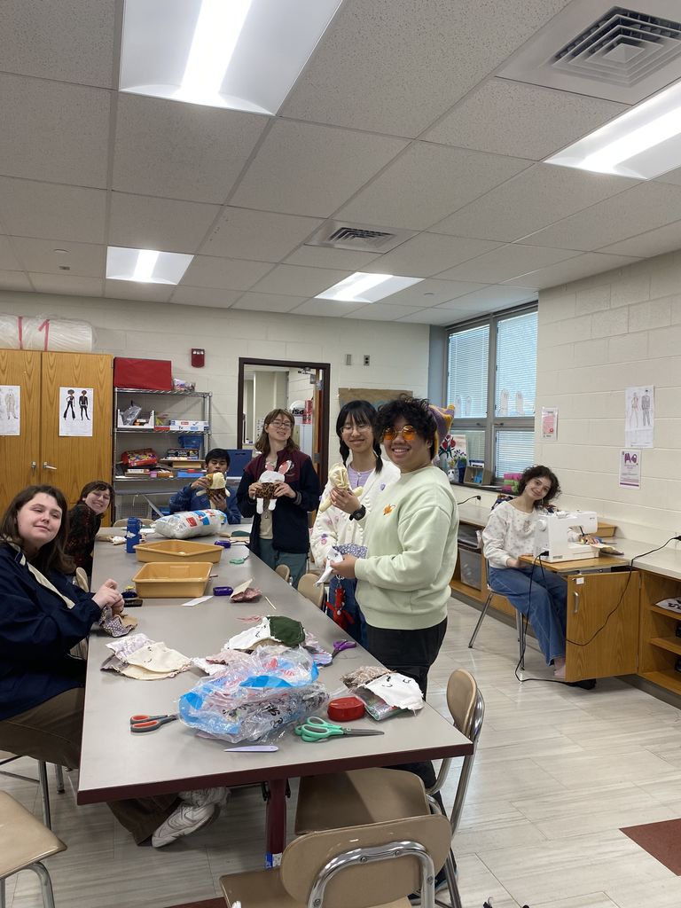 a group of teenagers cutting cloth