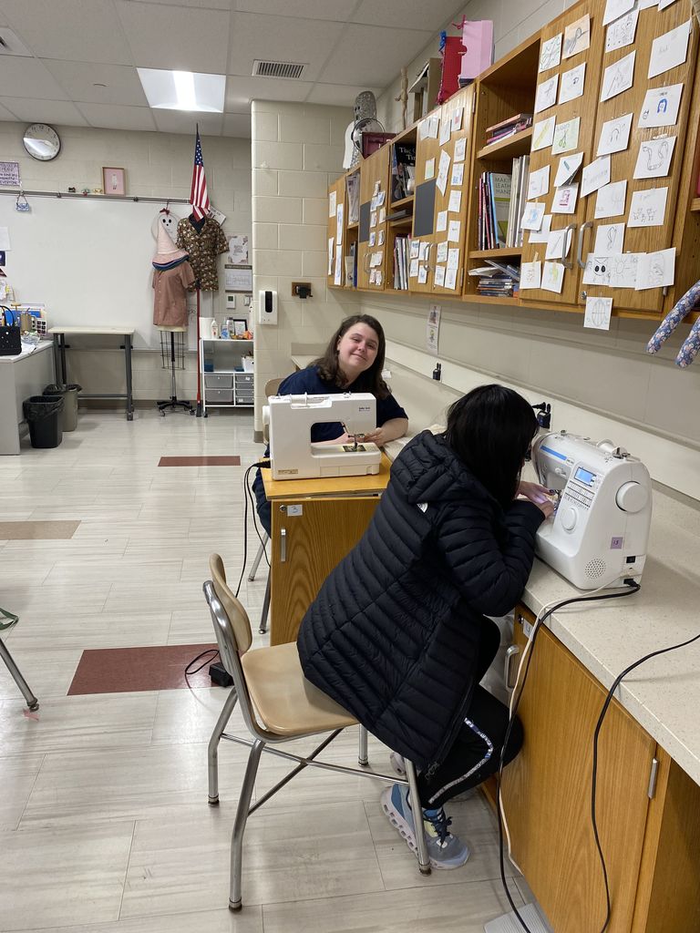 2 girls at a sewing machine